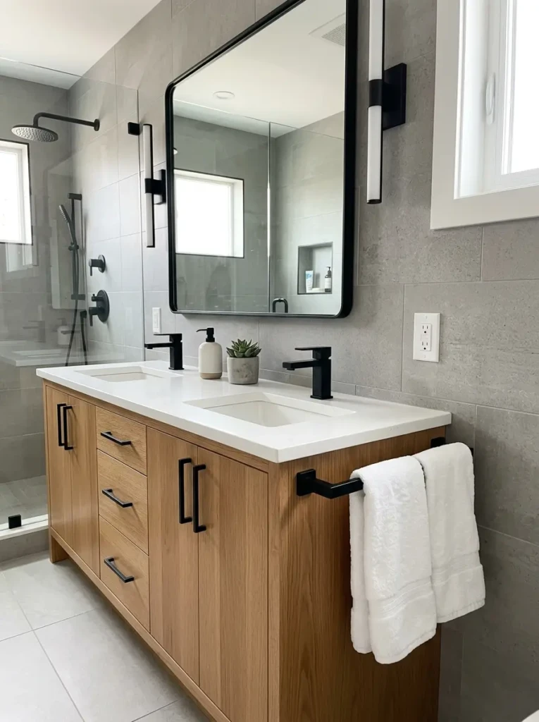 Coordinated cabinet handles and towel bars in a polished small bathroom design